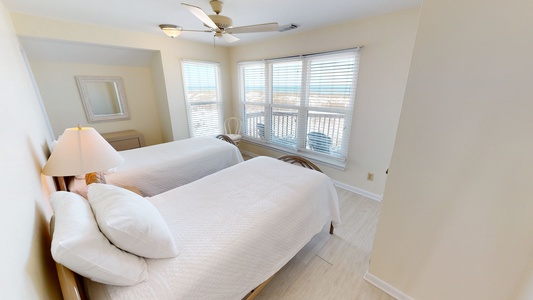 Bedroom 3 comes with a ceiling fan and beach views
