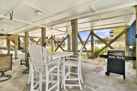 The carport offers a propane grill and outdoor dining