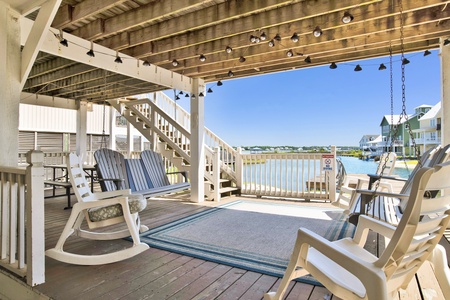 Shaded  area under the home with 2 swings and rockers