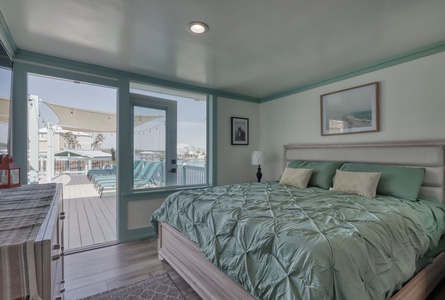 The guest bedroom has balcony access and a TV