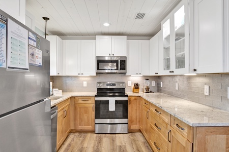 Full equipped kitchen with stone counters and stainless appliances