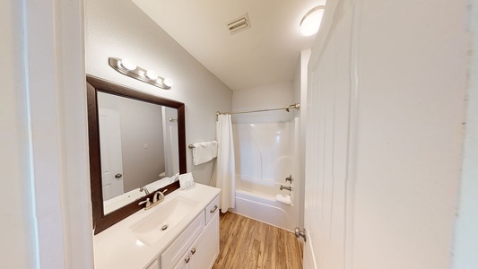 The private bathroom for Bedroom 2 has a tub/shower combo