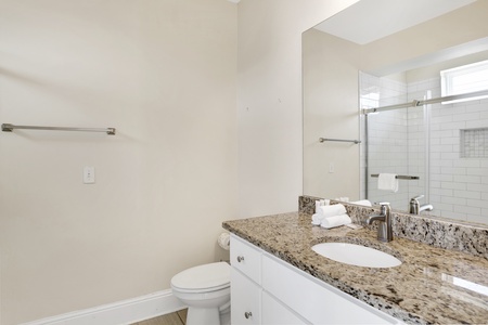 The private bath in Bedroom 2 has a walk-in shower