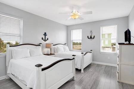 Bedroom 2 on the main floor has two full beds, tv, and a private bath