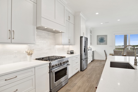 The kitchen offers stainless steel appliances and stone counters