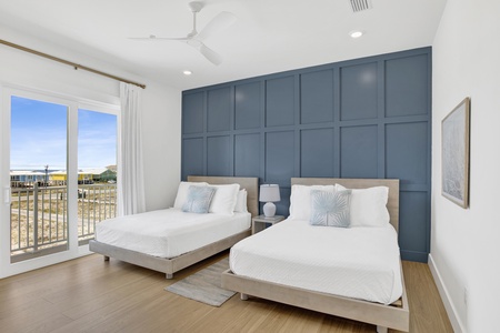 Bedroom 3 has a private bathroom, balcony access, TV and two Queen beds, sleeps 4