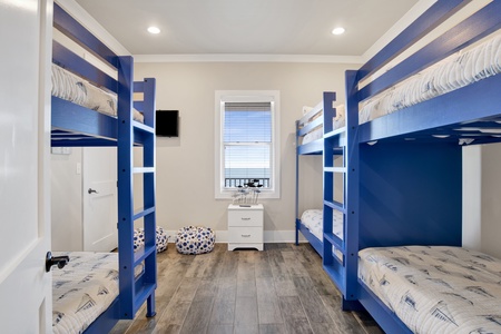 2nd floor bedroom 6 sleeps 6 and has a mounted TV