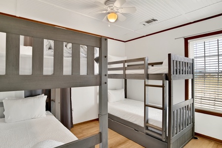 Bunk room with 2 sets of twin bunks and 1 twin trundle