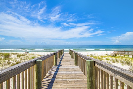 Private boardwalk to the beach with shower