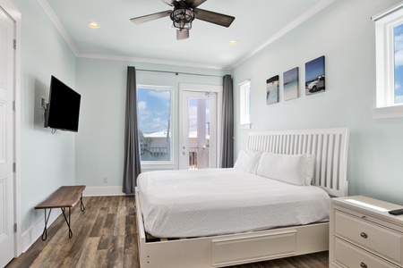 Bedroom 6 offers a King bed, TV, balcony access and attached, shared bathroom