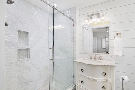 The master bathroom features a walk-in tile shower