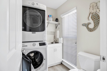 Full size washer and dryer along with a half bath