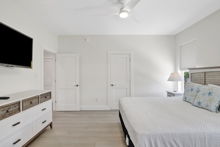 Bedroom 1 features a TV, ceiling fan and a private bathroom