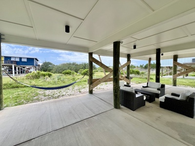 The carport offers seating and a hammock for lounging