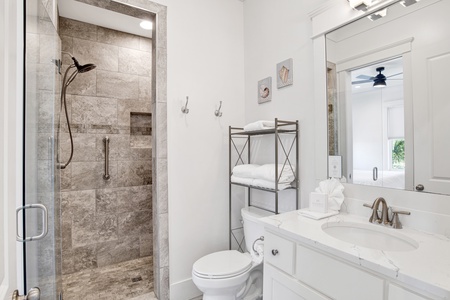 The private bathroom features a walk-in tile shower