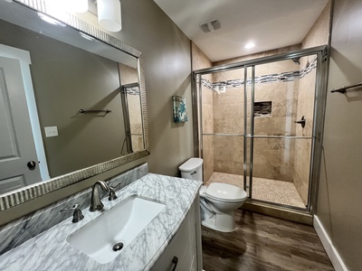 Private bathroom with tile shower