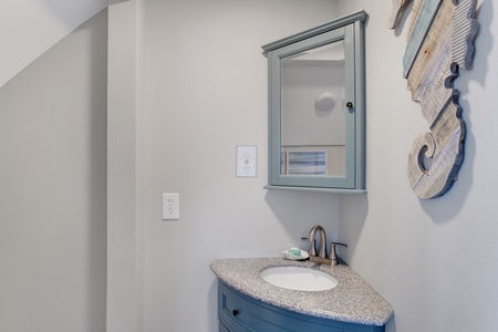 Half bathroom located in the hallway, right off the living room