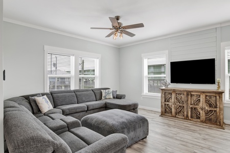 The living room offers a TV and sleeper sofa, accommodating 2 guests