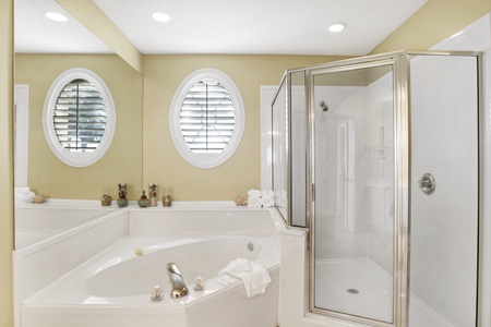 Private master bath with a jetted tub and a walk-in shower