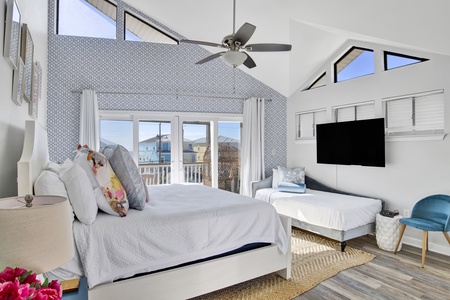 Hello Sunshine (Unit A)  Master bedroom with a king bed, TV, balcony access and a private bathroom