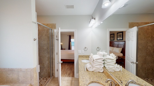 The private bath in Bedroom 6 has a double vanity and a walk-in shower