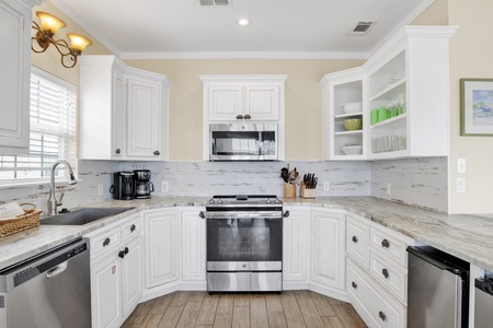 Updated kitchen with stainless appliances, tile backsplash and granite countertops