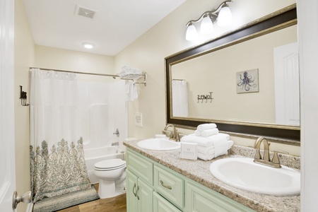 Shared hall bathroom features a tub/shower combo
