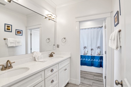 The shared hallway bathroom features dual vanities and a tub/shower combo