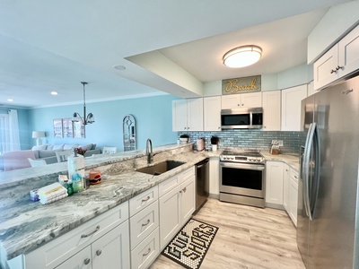 Fully equipped kitchen with stainless appliances and stone countertops