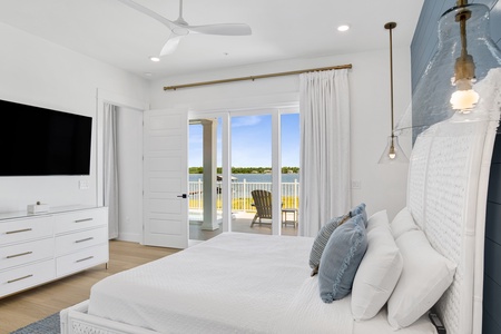 The primary bedroom offers a TV and balcony access