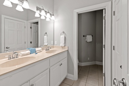 2nd floor shared hall bath with a double vanity and tub/shower combo