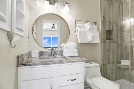 The private ensuite features a walk-in tile shower