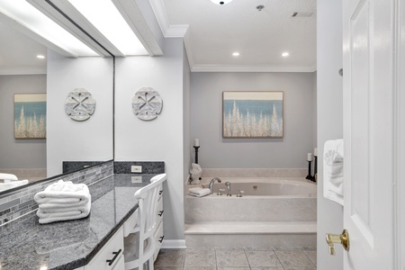 Large soaking tub and vanity area in the private master bathroom
