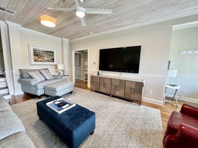 The living room offers comfortable seating and a flat screen TV