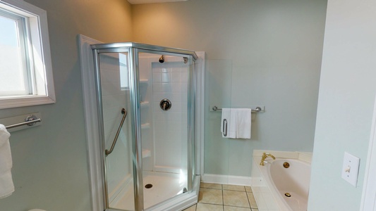 The master bath features a jetted soaking tub and a walk in shower