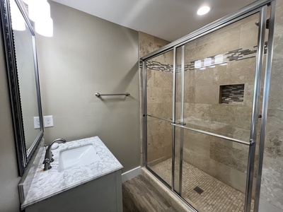 Private bathroom with tile shower