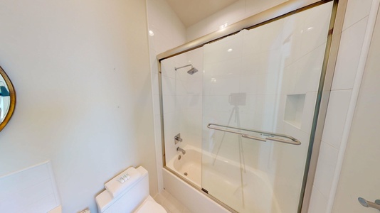 The tub shower combo in the private bath in Bedroom 1