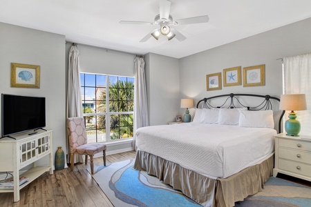 1st floor master bedroom with a king-size bed and balcony access