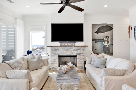 Comfortable seating and a large mounted TV above the fireplace