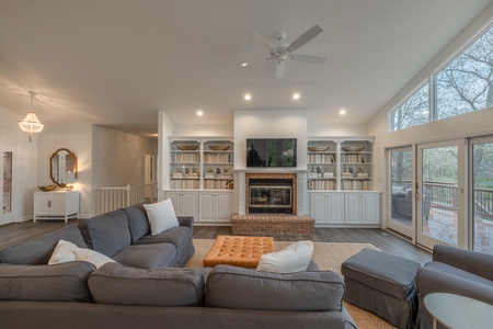 Custom, built-in shelving surround the fireplace and provide a modern, yet cozy touch in the center of the home