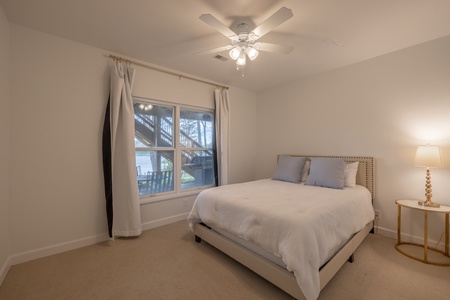Just downstairs, the third guest bedroom contains one queen bed and gorgeous views of the outdoors