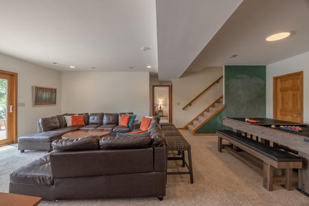 When you're ready to explore the outdoors, sliding glass doors open up to the lower level patio sitting area