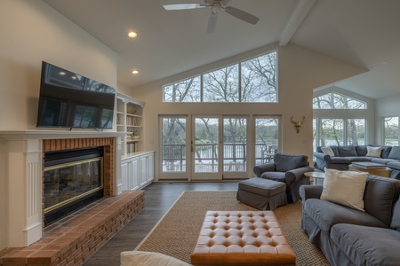 Vaulted ceilings and oversized windows allow natural lighting to grace the entirety of the open, airy living space