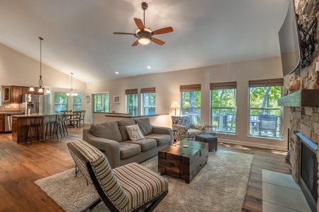 The open, airy living space is lined with oversized windows beautiful hardwood floors