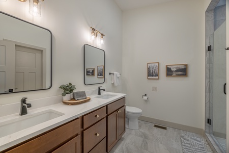 Stunning primary bathroom with ceramic tile flooring and double vanity sinks