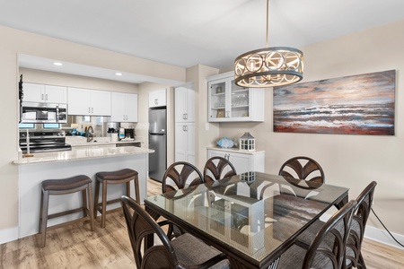 Gather around your elegant glass dining table while the chef prepares meals in the open kitchen.