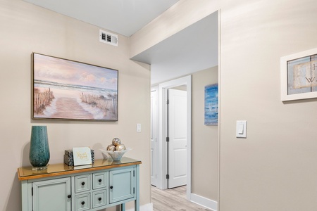 Step into your coastal-inspired entryway where soothing artwork and thoughtful decor create an instant sense of vacation tranquility.