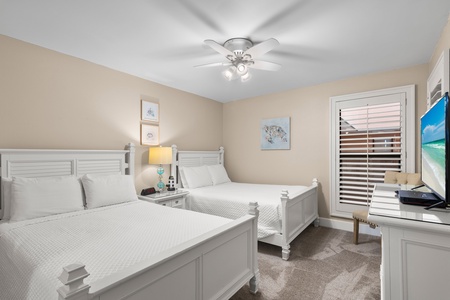 Drift off peacefully in one of the 2 double size beds with soft linens, gentle ceiling fan, and coastal artwork creating the perfect retreat.