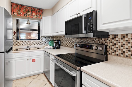 Your fully equipped kitchen awaits with modern appliances, stylish tile backsplash, and everything you need to prepare meals during your stay.