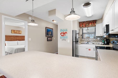 Step into your open-concept retreat, where the kitchen flows seamlessly into the living space. Enjoy your morning coffee at the spacious counter before retreating to your cozy bedroom just steps away.